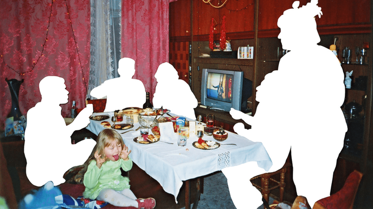 Family sat at a dining table with outlines missing