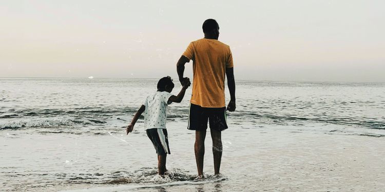 We’re All Going to Be Someone’s Ancestor One Day A man and young boy holding hands along the shoreline