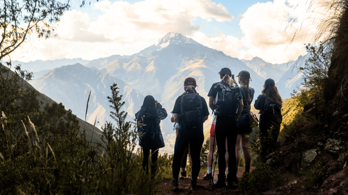 hikers look at mountain view