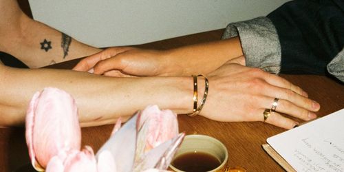 Picture of hands touching at a cafe table
