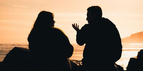 Picture of couple speaking while watching sunset